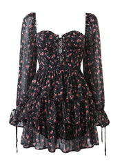 Black floral dress with sheer long sleeves on a white background