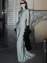 Person wearing a long, light-colored dress with a blurred background