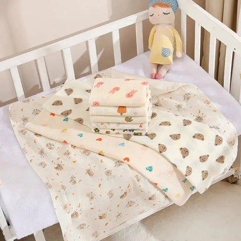 Baby blankets with cartoon patterns on a crib with a plush toy.