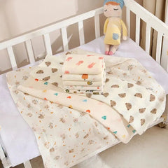 Baby blankets with cartoon patterns on a crib with a plush toy.