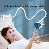 Multifunctional mobile phone holder being used by a person lying in bed.