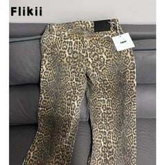 Leopard print pants with a tag on a gray couch, branded 'Flikii'.