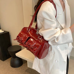 Person holding a red handbag in an indoor setting