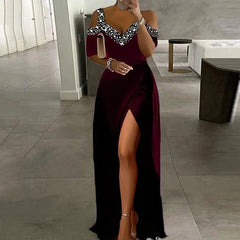 Woman wearing a burgundy off-shoulder dress with a high slit in a modern interior setting.