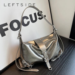 Silver handbag on a textured surface with 'LEFTSIDE FOCUS' text in the background