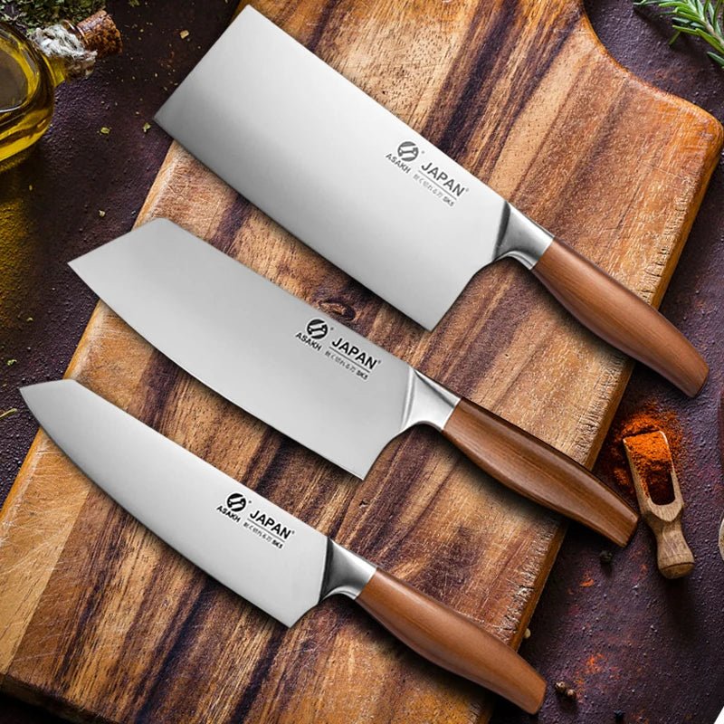 Three Japanese knives with wooden handles on a wooden cutting board.