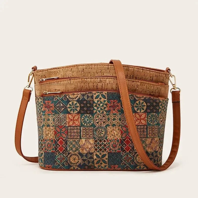 Patterned handbag with brown leather straps on a beige background