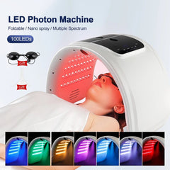 LED Photon Machine with a person receiving treatment, featuring 100 LEDs and gift items.
