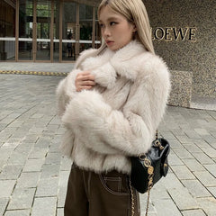 Woman wearing a fur coat in front of a Loewe store.