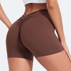 Brown athletic shorts worn by a person on a light gray background