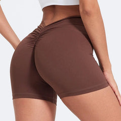 Brown athletic shorts worn by a person on a light gray background
