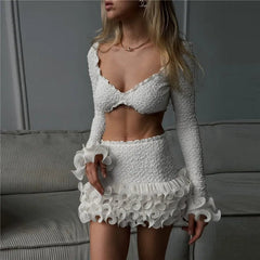 Woman wearing a white textured outfit in a neutral setting
