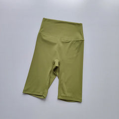 Green athletic shorts on a light gray background