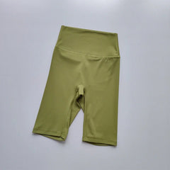 Green athletic shorts on a light gray background