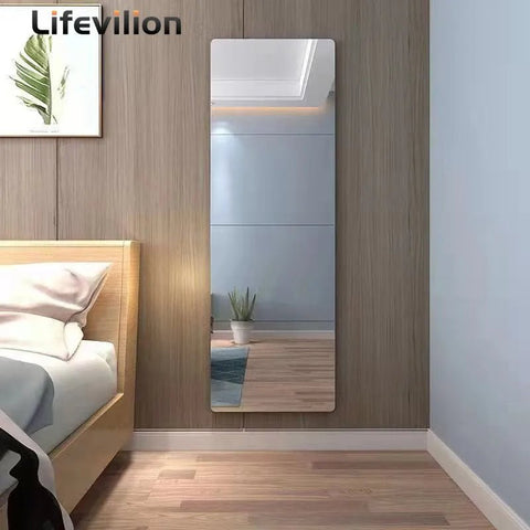 Full-length mirror leaning against a wooden wall in a bedroom setting with 'Lifevilion' branding.