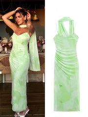 Woman wearing a light green evening gown in an indoor setting