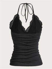 Black halter top with lace detailing on a white background