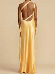 Yellow evening gown with thin straps on a beige background