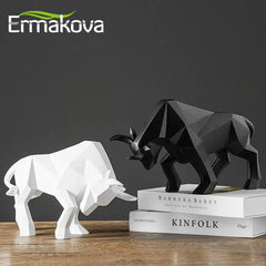 Two resin figurines, one black and one white, shaped like a bison and a rhinoceros, placed on a table with a book titled 'Kinfolk' in the background.