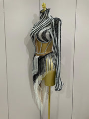 Black and white striped outfit with fringe on a mannequin against a plain background