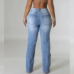 Light blue jeans worn by a person on a plain background