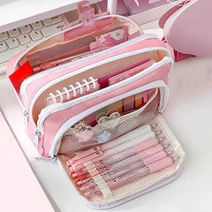Pink pencil case with stationery items on a white surface