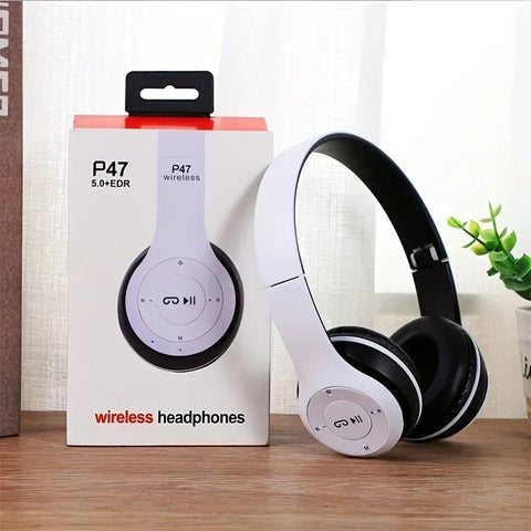 Wireless headphones with packaging on a wooden surface