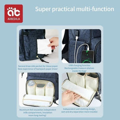 Multifunctional backpack with various compartments and features on a light blue background.