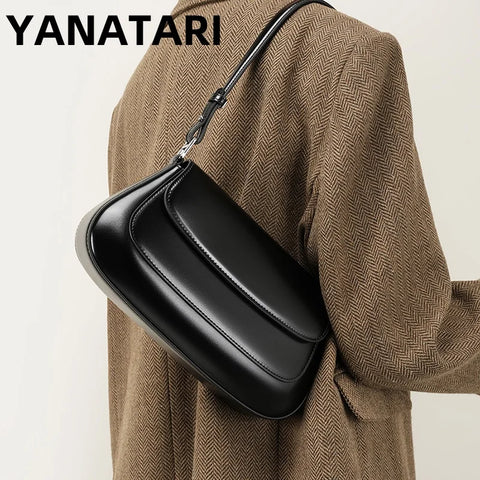 A black genuine leather handbag with a single handle, worn on the shoulder, with the brand name 'YANATARI' visible at the top.