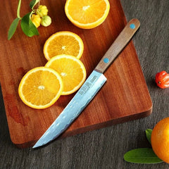 Knife on a wooden cutting board with sliced oranges