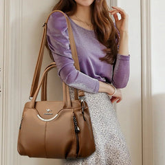 Woman holding a brown handbag with a neutral background