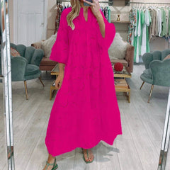 Person wearing a bright pink dress in a clothing store.