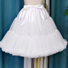 White petticoat on a mannequin against a blue curtain background