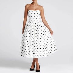 White strapless dress with black polka dots on a white background