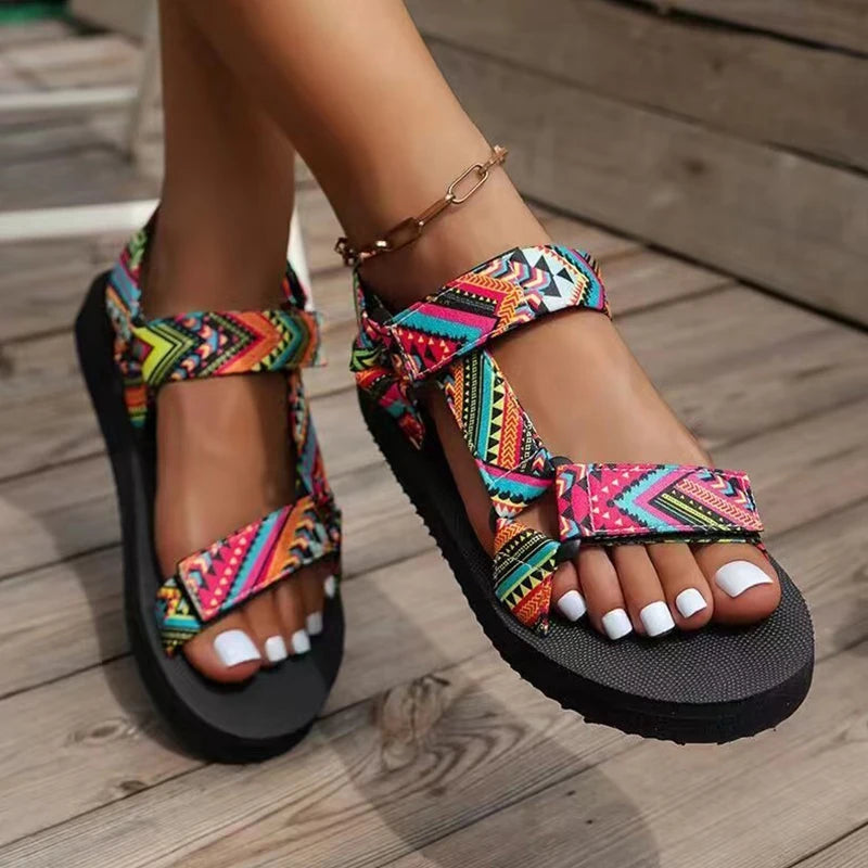 Colorful patterned sandals on a wooden floor