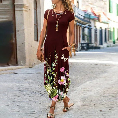 A woman wearing a red, floral print, short-sleeved, A-line bohemian dress with pockets, made from polyester, walking down a street.