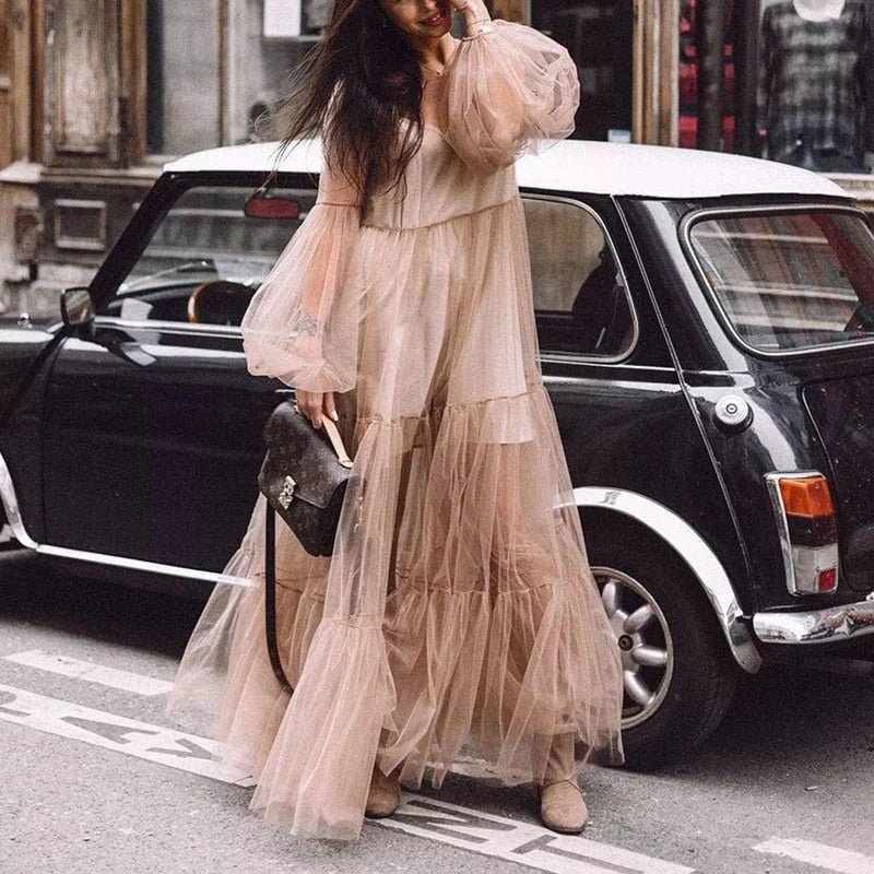 A woman wearing an elegant vintage lace fairy dress with three-quarter sleeves and a mid-calf length. The dress features a solid pattern with a flattering waistline and is paired with an O-neckline.