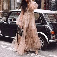 A woman wearing an elegant vintage lace fairy dress with three-quarter sleeves and a mid-calf length. The dress features a solid pattern with a flattering waistline and is paired with an O-neckline.