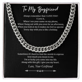 A silver Cuban chain necklace with an inscription for a boyfriend on a black background, indicating it is a gift typically used for occasions like birthdays or anniversaries.