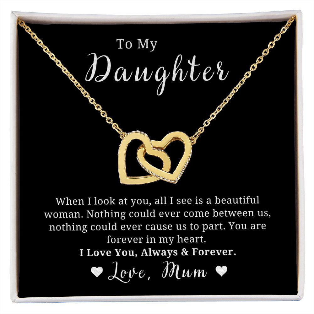 A necklace with two heart-shaped pendants, encapsulated in a black case with a quote to a daughter, and a space for a personal message.
