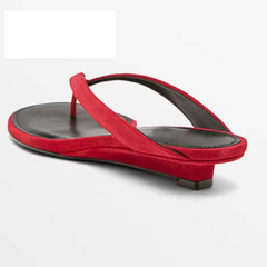 Red sandal with a black sole on a white background