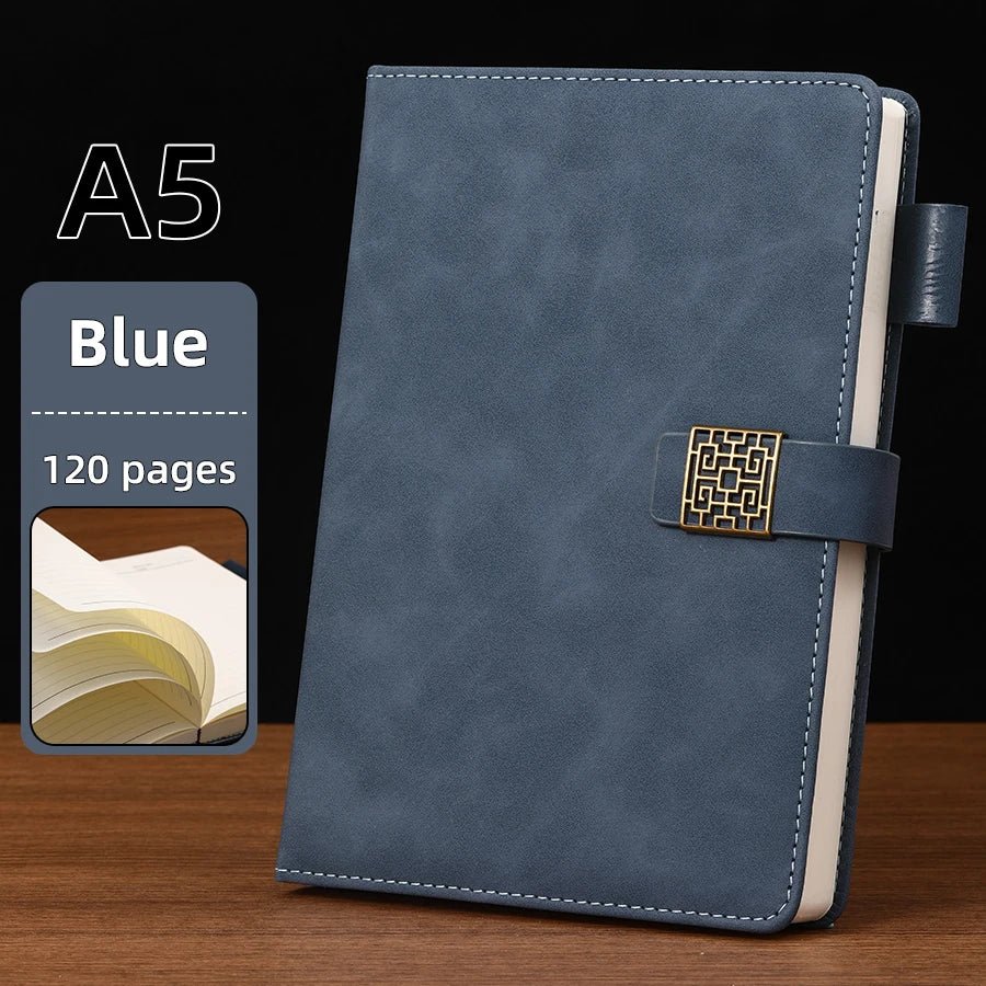 Blue A5 notebook with gold buckle on a wooden surface