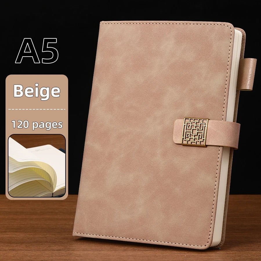 Beige notebook with a strap closure on a wooden surface, with text indicating A5 size and 120 pages.