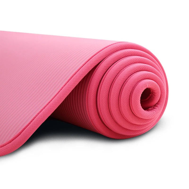 Rolled-up pink yoga mat on a white background