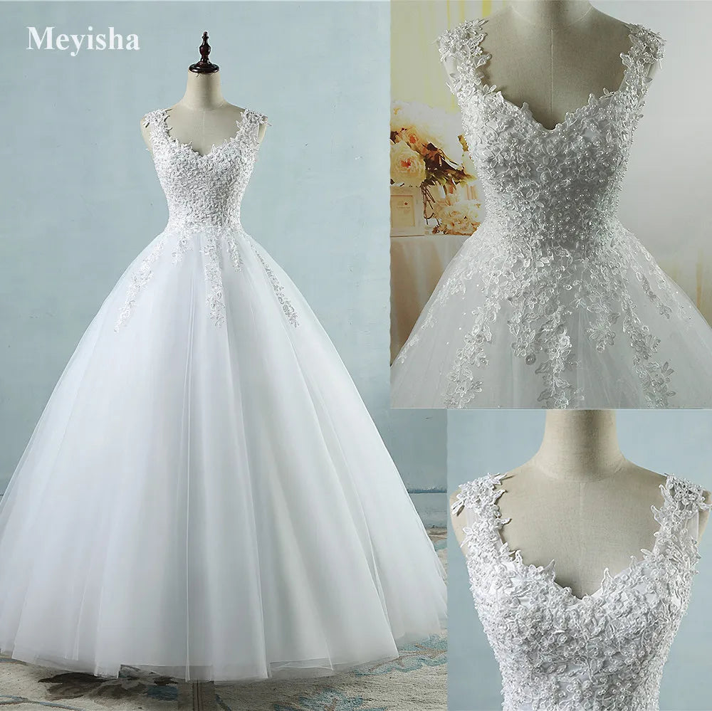 White wedding dress with lace details on a mannequin against a light blue background.