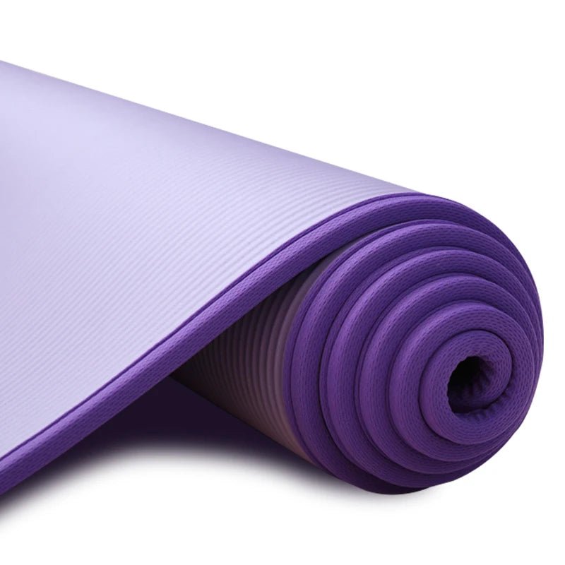 Purple yoga mat rolled up on a white background