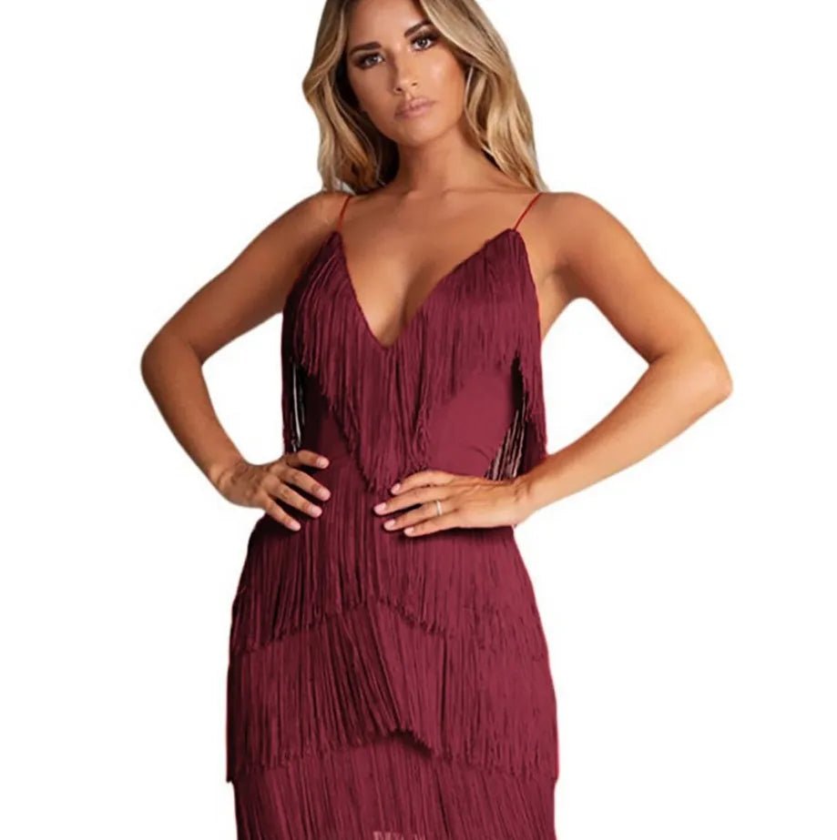 Woman wearing a burgundy fringe dress on a white background