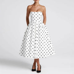 White strapless dress with black polka dots on a white background
