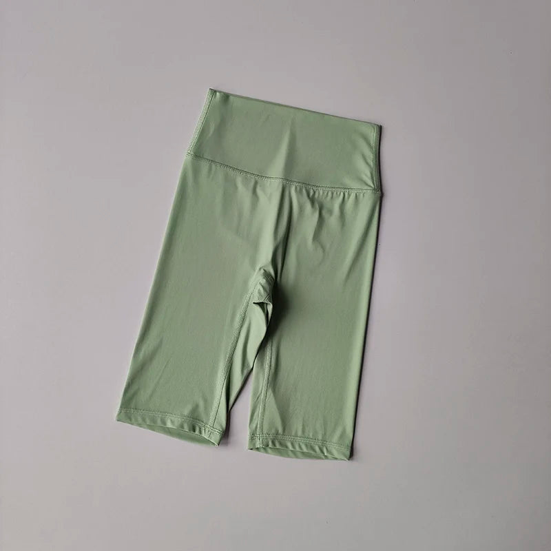 Green athletic shorts on a gray background