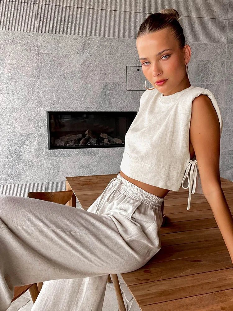 Woman sitting on a wooden floor in a modern living room with a fireplace.